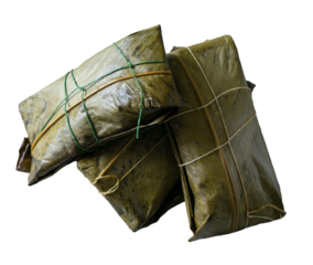 Three tamales wrapped in banana leaf on white background.