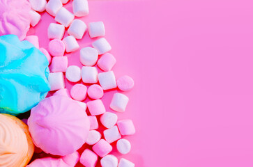 Pink blue white marshmallows on pink background Sweet marshmallow colored candy sweets sweet powder Top view Flat lay Copy space Birthday card Girl