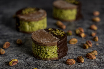 pistachio and chocolate alfajor gray background ready to eat