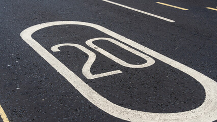 20mph speed sign painted on asphalt	
