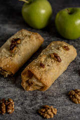Homemade apple and walnut strudel gray background ready to eat