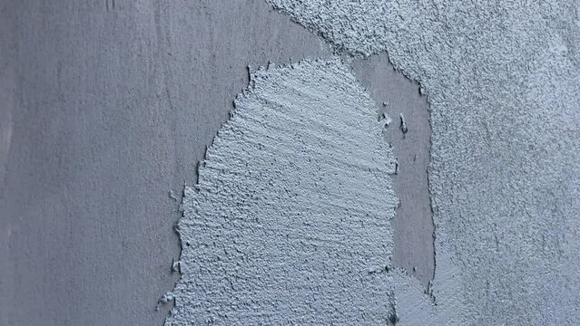 Repair of a private house, modern decorative plaster. Horizontal video of applying plaster to a wall.