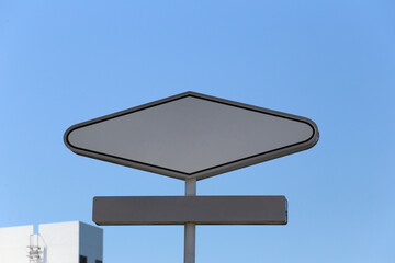 Blank metal sign on the sky background.