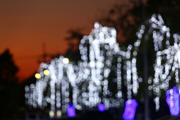Blur White bokeh of Christmas tree lights background.