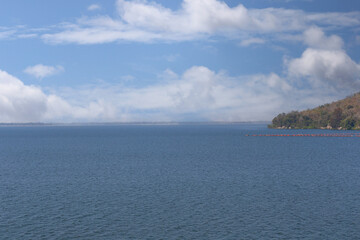 View of Ubonrat Dam during the day with sunlight and clear weather.