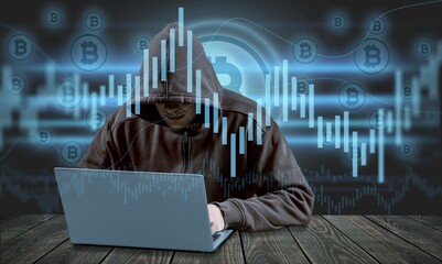 Hooded hacker look in laptop screen