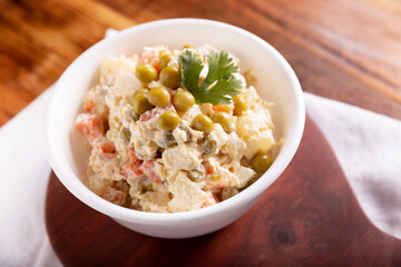 Russian Salad, also known as Olivier Salad. Very popular dish in several countries, the main ingredients are commonly potatoes, mayonnaise and vegetables such as peas, carrots, boiled eggs or chicken