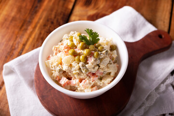 Russian Salad, also known as Olivier Salad. Very popular dish in several countries, the main ingredients are commonly potatoes, mayonnaise and vegetables such as peas, carrots, boiled eggs or chicken