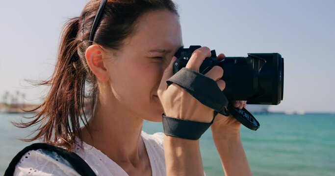 Female traveler take photo on camera of sightseeing in vacation. Cinematic and inspiring travel blogger live motivational adventure