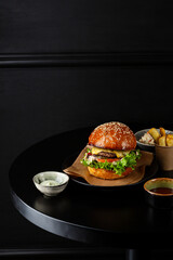 One cheeseburger on black table fast food background - 746071318