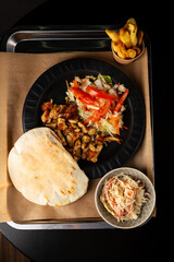 Overhead view of pita bread with meat and salad - 746071337