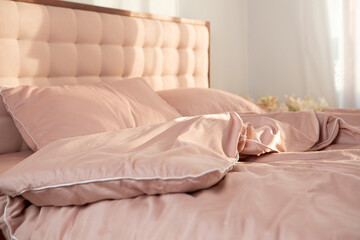 Fototapeta na wymiar wrinkled light pink bed linen morning routine
