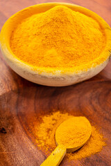 ground turmeric on a wood