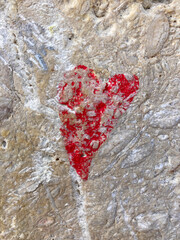Red hand drawn heart on rock, stone. A perfect background for works related to love, friendship, a symbol of love.