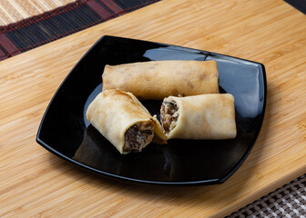 Pancakes stuffed with mushrooms on a plate.
