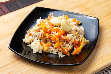 Chicken and garlic pilaf made from rice and carrots.