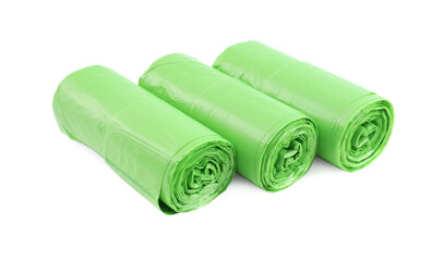 Rolls of light green garbage bags isolated on white