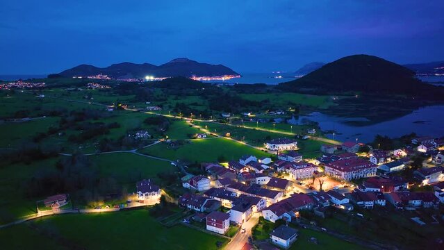 Dusk in the town of Escalante seen from a drone in the Parque Natural de las Marismas de Santo&ntilde;a, Victoria y Joyel Natural Park. Cantabrian Sea. Escalante, Cantabria, Spain, Europe