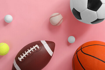 Many different sports balls on pink background, flat lay