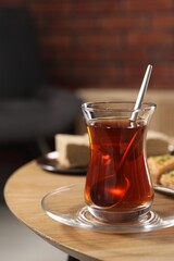 Traditional Turkish tea in glass on wooden table