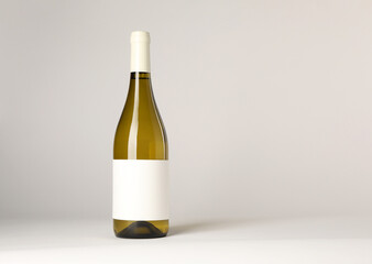 Bottle of tasty wine on white background, space for text