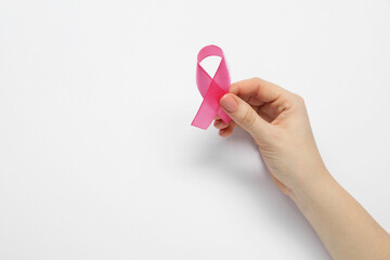 Breast cancer awareness. Woman with pink ribbon on white background, top view. Space for text