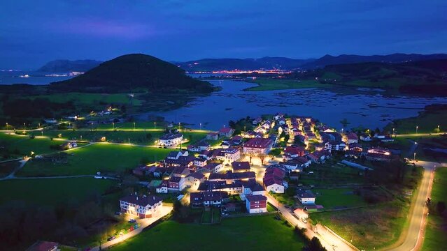Dusk in the town of Escalante seen from a drone in the Parque Natural de las Marismas de Santo&ntilde;a, Victoria y Joyel Natural Park. Cantabrian Sea. Escalante, Cantabria, Spain, Europe