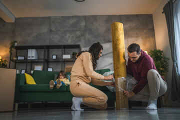 young couple moving in new apartment carry assembly furniture