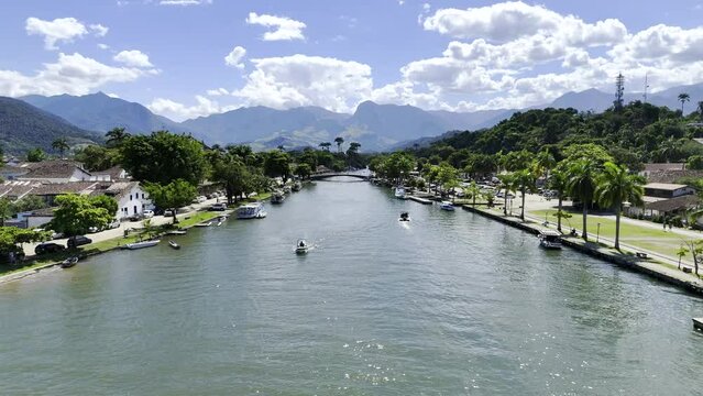 Aerial shot drone flies low over canal toward bridge