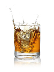 Whiskey splashing out of glass on white background
