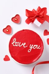 Bento cake with text Love You, candles, gift box and paper hearts on white table, flat lay. St. Valentine's day surprise