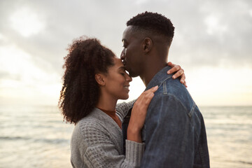 Loving young multiethnic couple sharing a romantic moment on a beach - Powered by Adobe