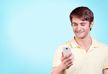 Happy young smart man hold mobile phone chatting,