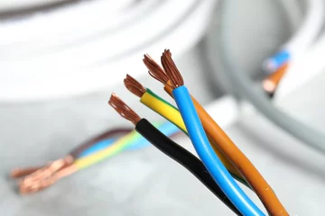 Fototapeten Colorful electrical wires on blurred background, closeup © New Africa