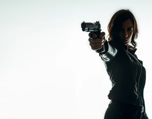 Foto op Aluminium Silhouette of a tough woman holding a gun. Isolated white background with copy space. Private detective. Investigator. Mystery, thriller, action packed pose. Back light. © ana