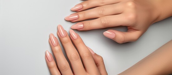 Close-up of a womans hands showcasing a fresh manicure on her nails. The nails are painted and perfectly groomed, with a glossy finish, set against a clean white background. - Powered by Adobe
