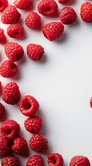 raspberries on a white background with space for text.