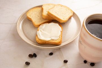 Toast with cream cheese in a marbled background in aerial view