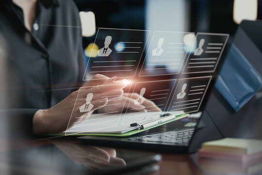 Manager working in the office with the resumes of the employees .