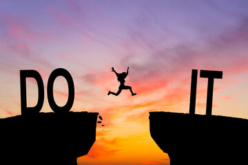 Silhouette man jumping over I can do it wording on cliffs with cloud sky and sunrise. Never give...