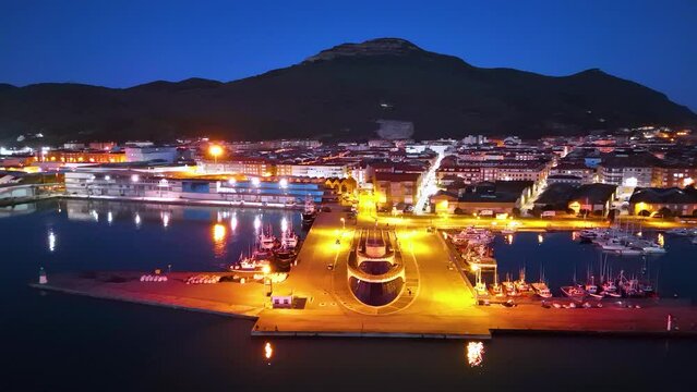 Dusk lights and fishing boats in the fishing village of Santo&ntilde;a in the Marismas de Santo&ntilde;a, Victoria y Joyel Natural Park. Cantabrian Sea. Santo&ntilde;a, Cantabria, Spain, Europe