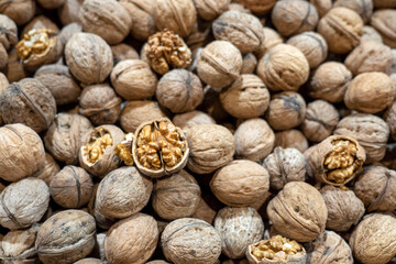 dried walnuts in shell for sale in the market, close-up shelled walnuts,
