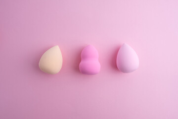Beauty blender on a colored background. Bright sponges for cosmetics. Makeup products. Beauty concept. Place for text