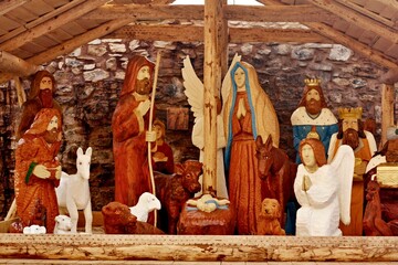 Wooden nativity scene, outdoor Christmas decoration. Hand-carved sculptures in the exterior.