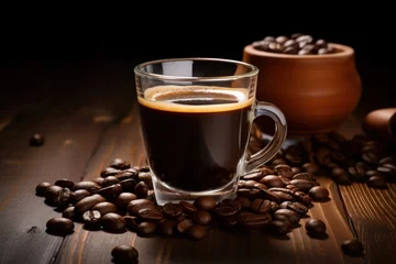  Black coffee in glass cup with coffee beans on wooden table © Graphics Box