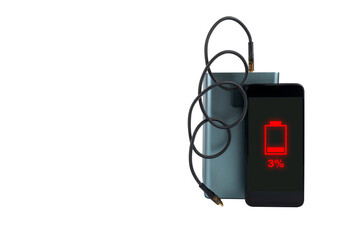 A smartphone next to a large power bank (charging station) with a USB cable on a transparent background. On the smartphone screen there is a red 3% battery charge indicator (low charge)