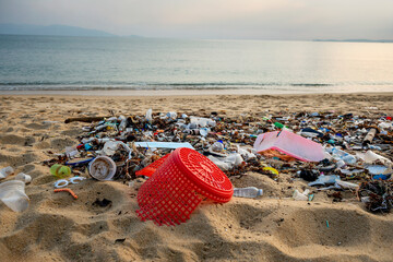 Plastic waste on the beach at sunrise