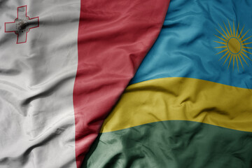 big waving national colorful flag of rwanda and national flag of malta.