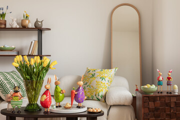 Sunny and design interior of living room with easter decorations, tulips, modular sofa, shelf,...