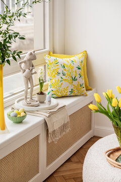 Easter compositions in stylish living room space with wooden windows sill, beautiful decorations, flowers, tulips and elegant accessories. Template. Easter holidays.  